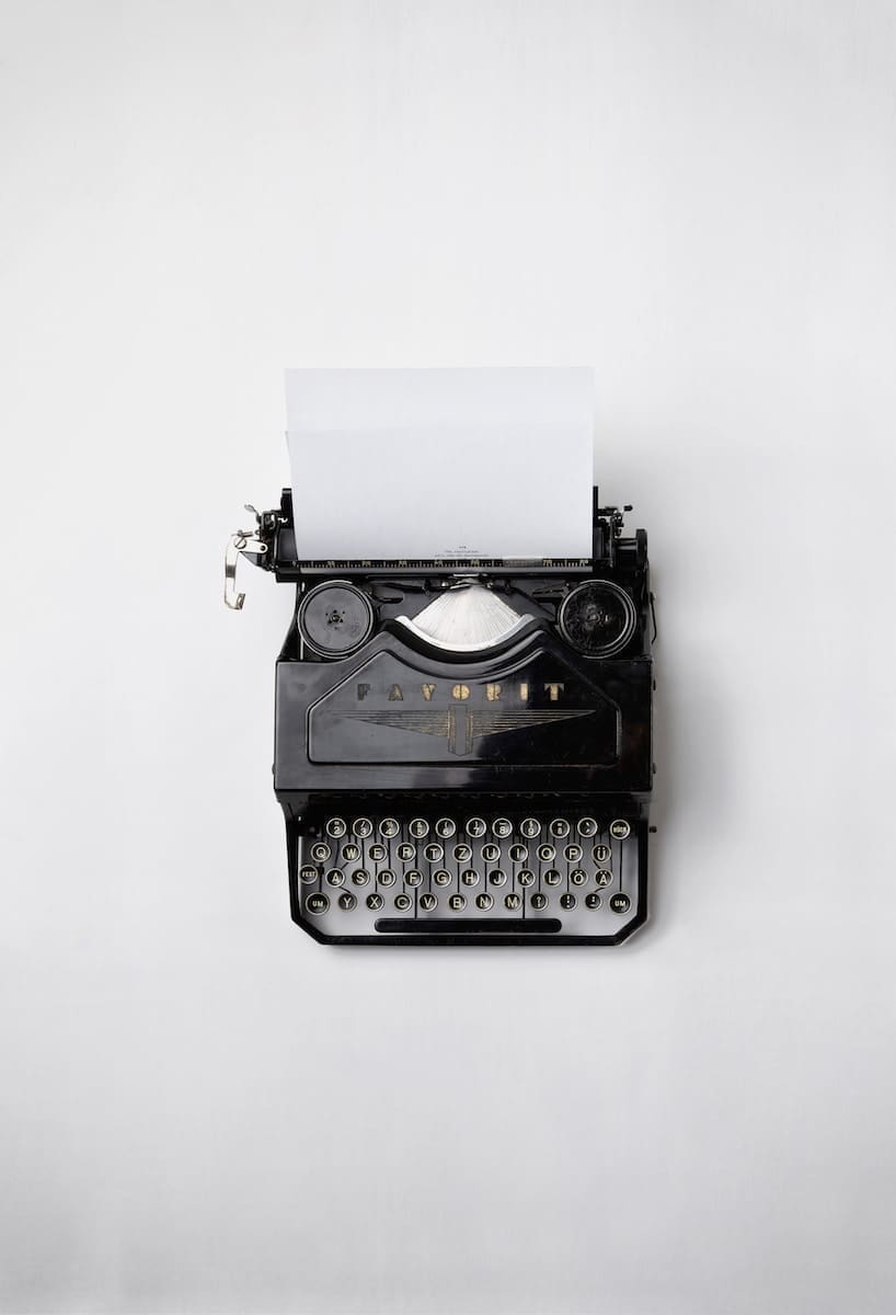 A black Fayorit typewriter with printer paper